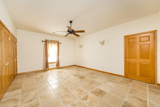 spare room with visible vents, baseboards, and ceiling fan