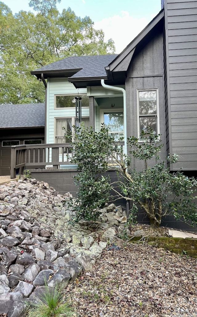 view of home's exterior with roof with shingles