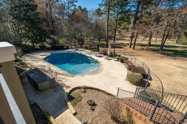 pool with a patio area and fence