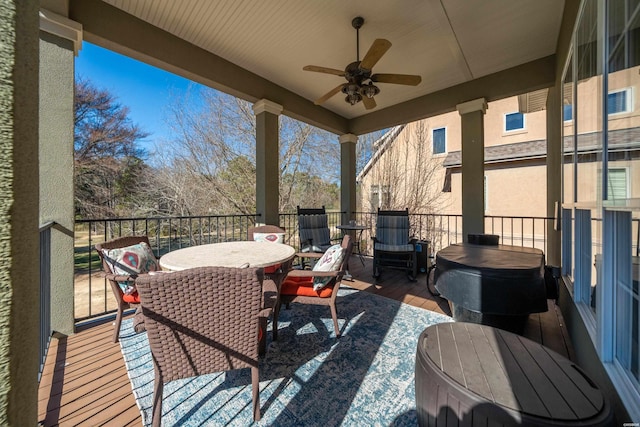 wooden deck featuring a ceiling fan and outdoor dining space