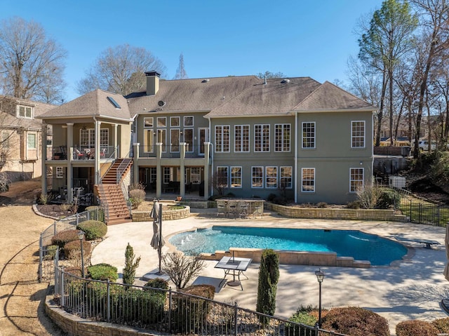 view of swimming pool featuring a fenced in pool, a jacuzzi, stairs, fence, and a patio area