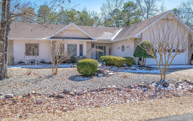 ranch-style home with driveway, brick siding, an attached garage, and a shingled roof