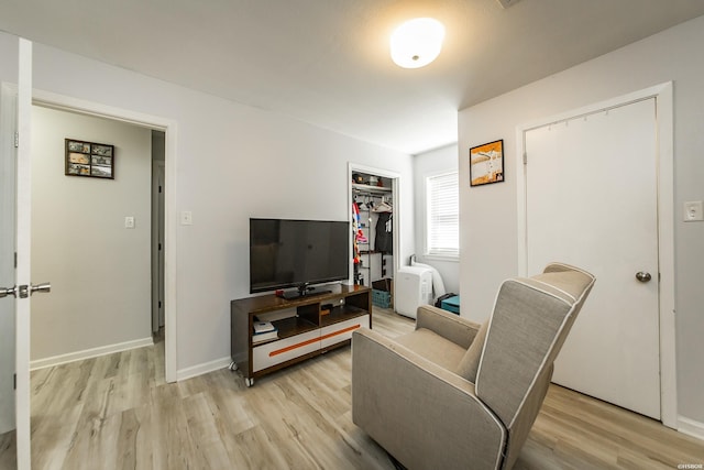 living room featuring baseboards and light wood-style floors