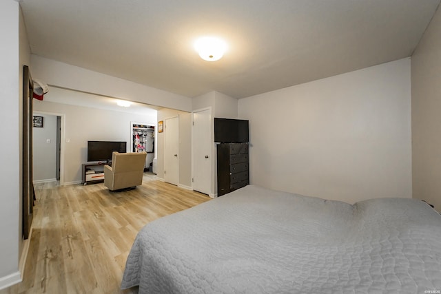 bedroom featuring light wood-style flooring and baseboards