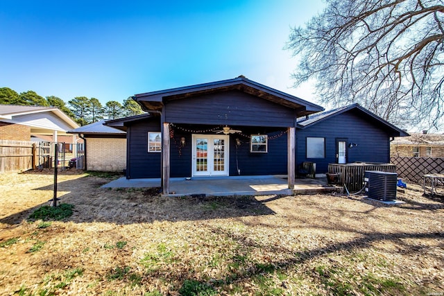 rear view of house with a patio, a ceiling fan, fence, french doors, and central air condition unit