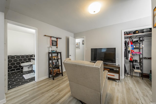 living area with baseboards and light wood-style floors