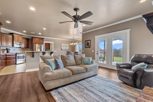 115 Gatehills Pl, Hot Springs, AR 71913 - living room featuring a chandelier, ornamental molding, recessed lighting, ceiling fan, and wood finished floors