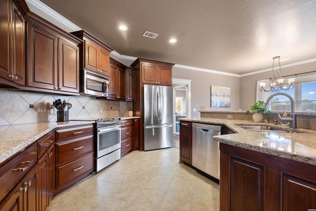 115 Gatehills Pl, Hot Springs, AR 71913 - kitchen with appliances with stainless steel finishes, ornamental molding, tasteful backsplash, light stone countertops, and pendant lighting