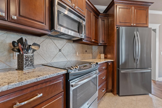 115 Gatehills Pl, Hot Springs, AR 71913 - kitchen with stainless steel appliances, ornamental molding, light stone countertops, backsplash, and light tile patterned flooring