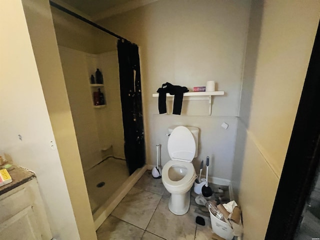 bathroom featuring a shower stall, toilet, and tile patterned floors