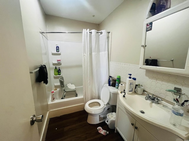 bathroom featuring tasteful backsplash, toilet, shower / bath combo, vanity, and wood finished floors