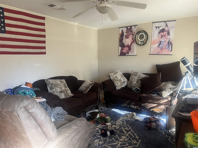 living room with ceiling fan, a textured ceiling, visible vents, and crown molding