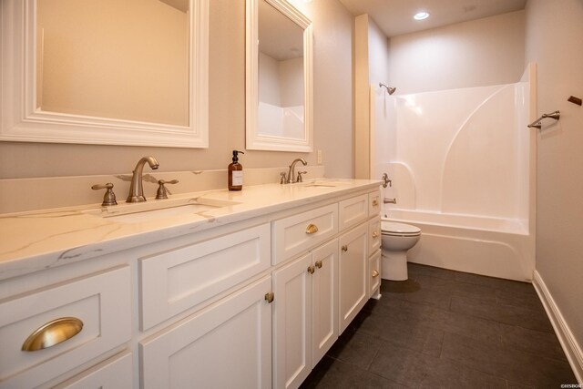 bathroom featuring  shower combination, double vanity, a sink, and toilet