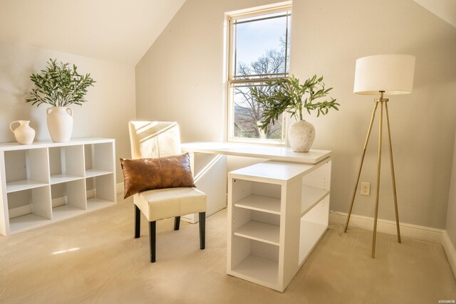 living area with lofted ceiling, baseboards, and light colored carpet