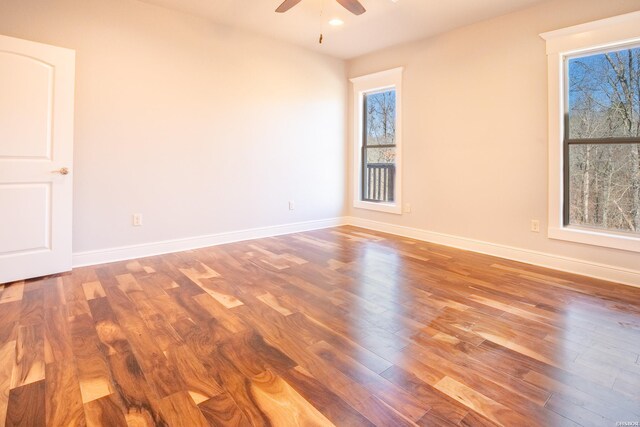 spare room featuring a ceiling fan, recessed lighting, baseboards, and wood finished floors