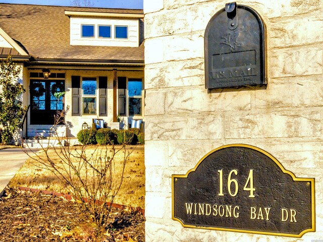 doorway to property featuring a shingled roof