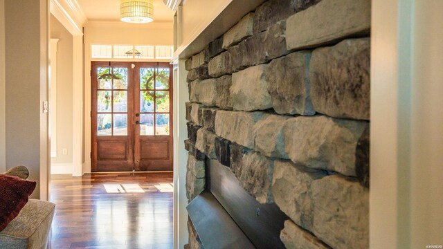 entryway featuring ornamental molding, wood finished floors, and french doors