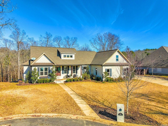 view of front of property with a front yard, covered porch, and concrete driveway