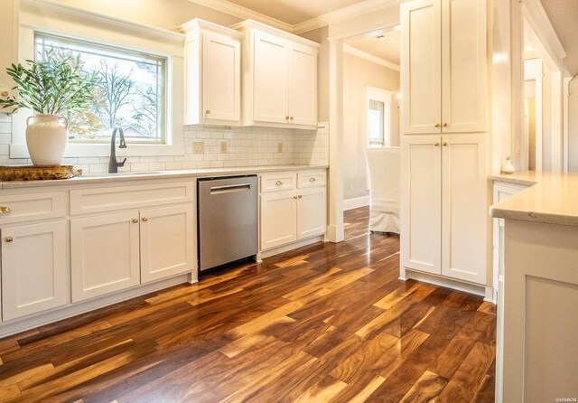 kitchen with dark wood-style floors, white cabinets, light countertops, dishwasher, and crown molding