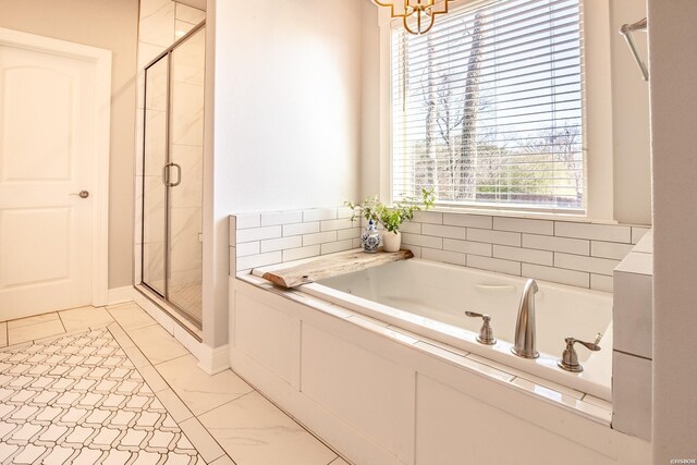 bathroom featuring a garden tub, a shower stall, and an inviting chandelier