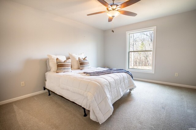 carpeted bedroom featuring a ceiling fan and baseboards