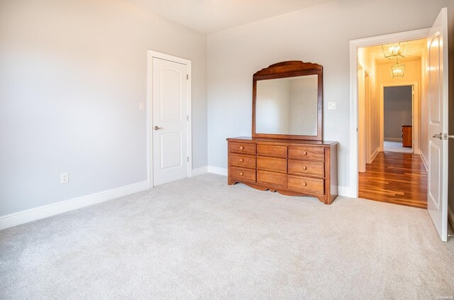 bedroom featuring baseboards and light colored carpet