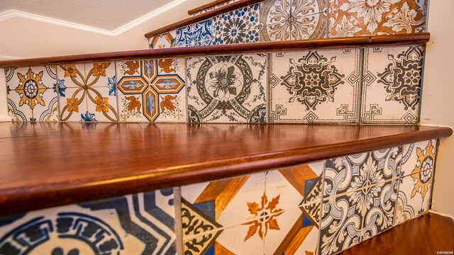 interior details with ornamental molding and a textured ceiling