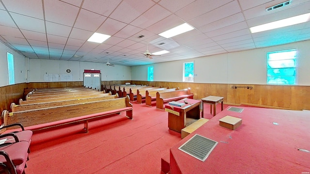 rec room featuring wooden walls, visible vents, a drop ceiling, and wainscoting