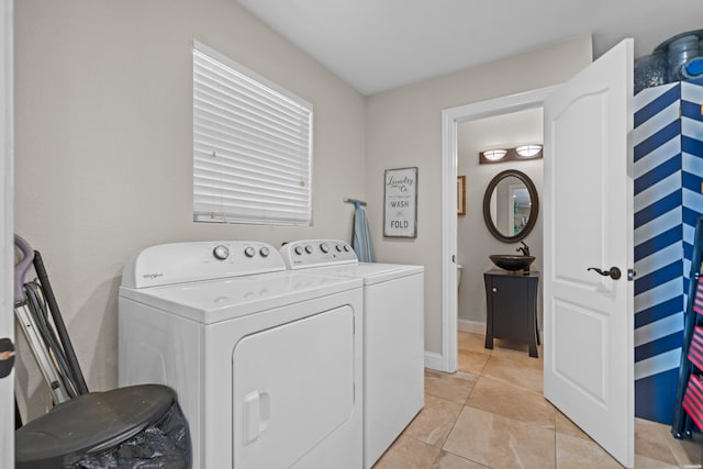 213 Gregory Dr, Hot Springs, AR 71913 - laundry area with light tile patterned flooring, a sink, laundry area, baseboards, and independent washer and dryer