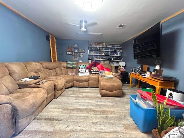 living area featuring ceiling fan, wood finished floors, and visible vents