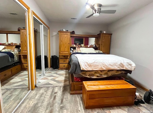 bedroom with visible vents, ceiling fan, and light wood finished floors