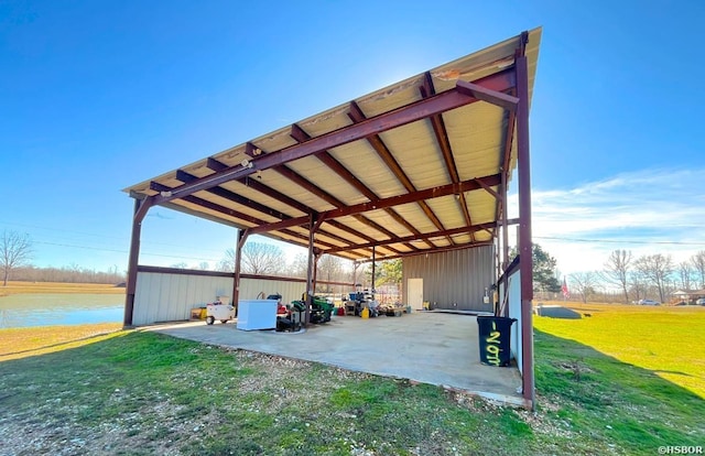 view of car parking featuring a water view and a carport