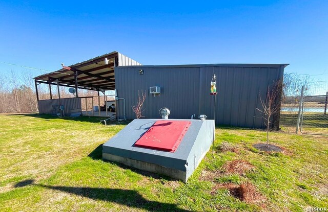 entry to storm shelter featuring a lawn