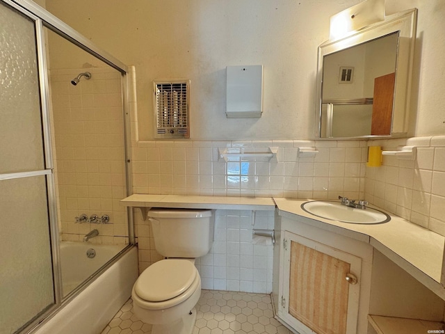 bathroom featuring tile walls, visible vents, toilet, vanity, and tile patterned floors