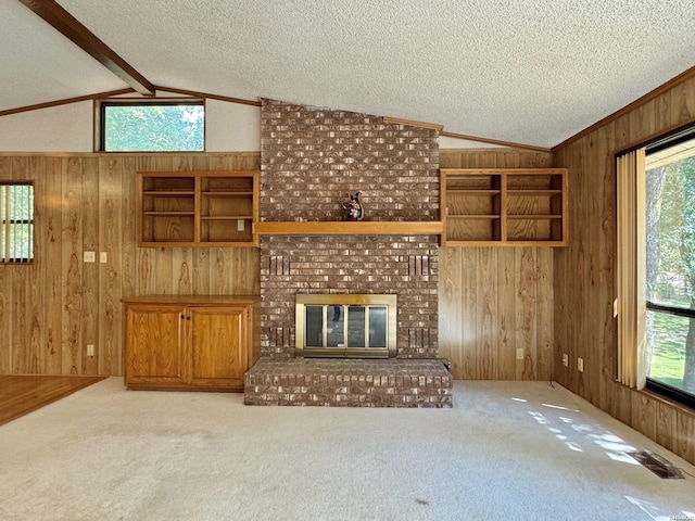 unfurnished living room with vaulted ceiling with beams, wood walls, and light carpet