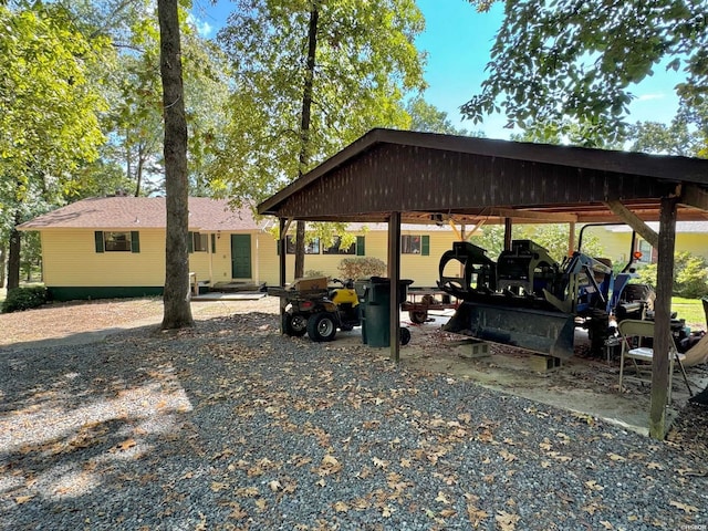 exterior space with driveway and a detached carport