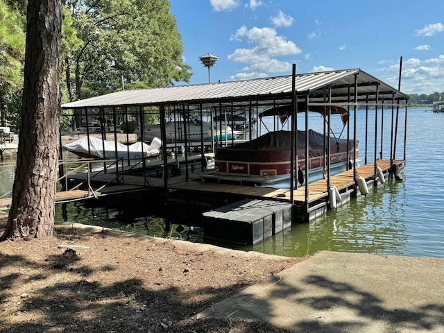 dock area with a water view and boat lift