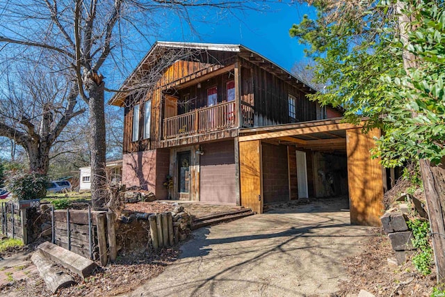 108 Helen St, Hot Springs, AR 71913 - back of house featuring driveway, a carport, and a balcony