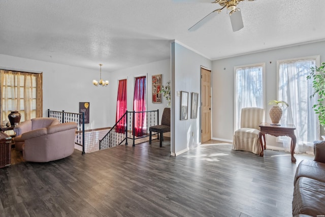 108 Helen St, Hot Springs, AR 71913 - living area featuring a textured ceiling, baseboards, dark wood-style flooring, and ceiling fan with notable chandelier