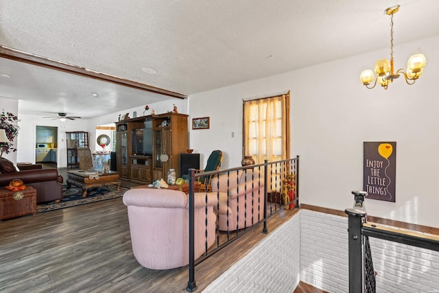 108 Helen St, Hot Springs, AR 71913 - living area featuring a textured ceiling, wood finished floors, and a notable chandelier