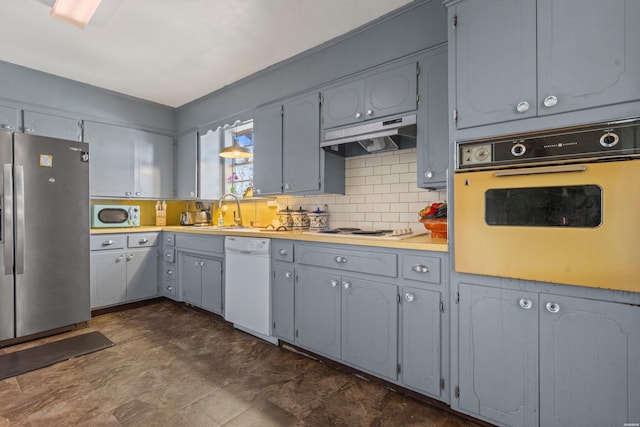 108 Helen St, Hot Springs, AR 71913 - kitchen with gray cabinetry, under cabinet range hood, white appliances, a sink, and tasteful backsplash
