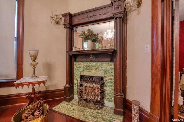 sitting room with a premium fireplace and an inviting chandelier