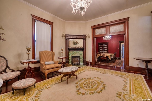 living area with a chandelier, a fireplace with flush hearth, baseboards, dark wood finished floors, and crown molding