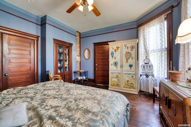 bedroom with dark wood finished floors, multiple windows, and crown molding