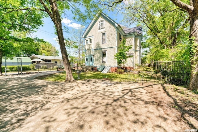 rear view of property with fence