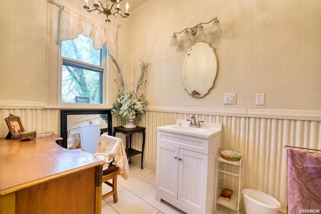 bathroom featuring a wainscoted wall, wallpapered walls, vanity, and an inviting chandelier