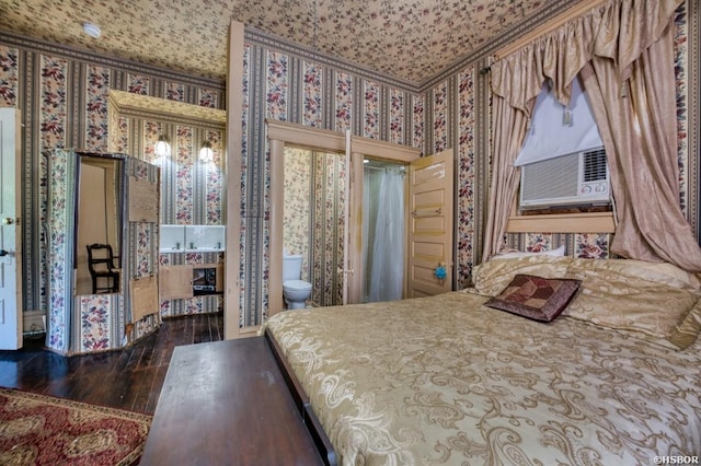 bedroom with crown molding, wood finished floors, and wallpapered walls