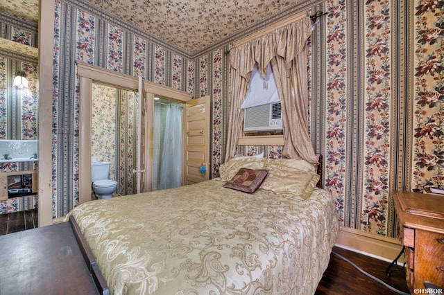 bedroom featuring dark wood-style flooring, cooling unit, and wallpapered walls