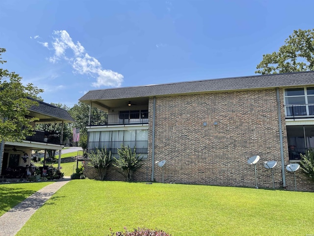 1135 Twin Pts Unit C, Hot Springs, AR 71913 - view of side of home featuring ceiling fan, a lawn, and brick siding