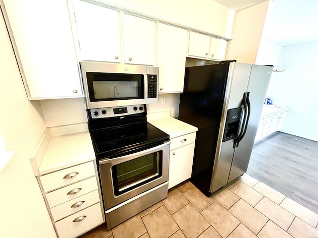 1135 Twin Pts Unit C, Hot Springs, AR 71913 - kitchen with stainless steel appliances, light countertops, white cabinetry, and light tile patterned floors